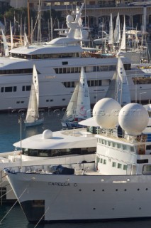 Superyachts moored in Monaco harbour port with yachts sailing