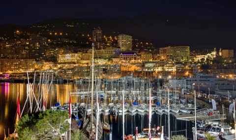 Superyachts moored in Monaco harbour port with yachts sailing