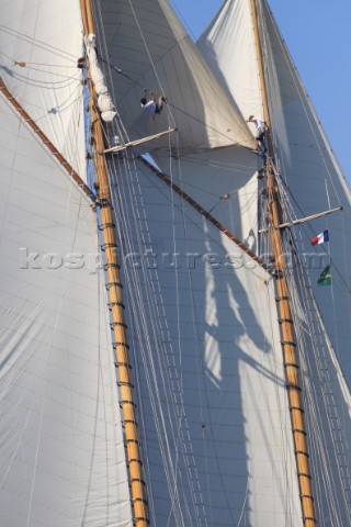 Les Voiles de SaintTropez 2011  crew climb the masts to set the fisherman sail