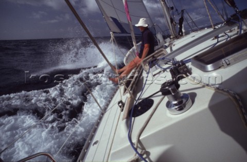 Man sitting on sailing yacht looking at view