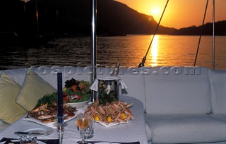 Set table on a sailing yacht during sunset