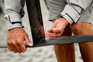 Man holding the foil of a GC32 catamaran