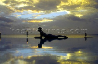 A young ladie relaxes on Honeymoon Island, Cook Islands, South Pacific.