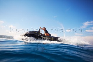 Man jet skiing in the mediterranean sea.