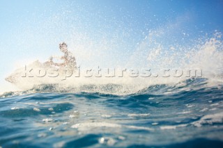 Man jet skiing in the mediterranean sea.