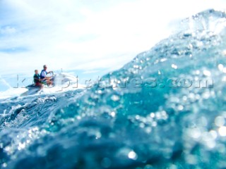 Man and young boy jet skiing in the mediterranean sea.