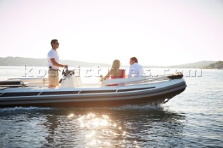 Couple on a tender driven by a member of crew