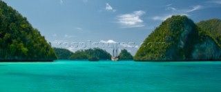 Cruising in Indonesia, traditional Phinisi at anchor in Wayag