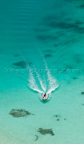 Cruising in Indonesia elevated view of a speedboat in Wayag Raja Ampat Islands