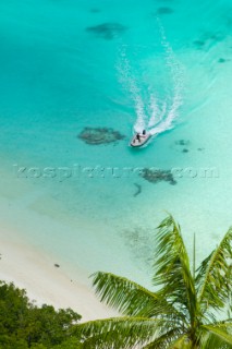 Cruising in Indonesia, elevated view of a speedboat in Wayag, Raja Ampat Islands