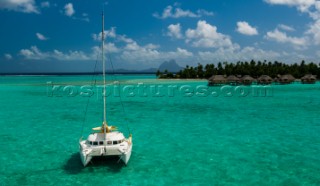 Catamaran moored near a small island in Raiatea