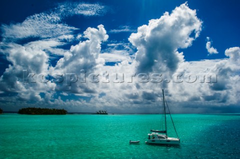 Catamaran moored near a small island in Raiatea