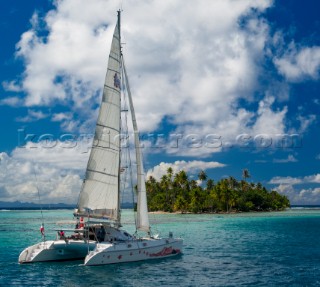 Catamaran moored near a small island in Raiatea