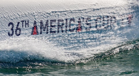 Bow wave splash of camera boat with AC logo