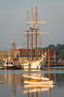 Tall ships moor in the Mystic River at Mystic Seaport in Mystic, Conn.