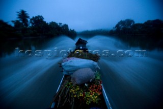 A boat goes down the Cayapas River leaving San Miguel, an Afro Ecuadorian community located 3 hours up the Cayapas River in Ecuador, on August 21, 2008.  Many of the pueblos in the province of Esmeraldas, Ecuador, have become more dangerous in recent years because of the drug trade and its proximity to the Colombian jungle.  Fishing is the only job in some villages.  A lack of opportunities has left many people frustrated, especially when there are less fish.  Although many of these communities are living in extreme poverty, a strong sense of identity and family holds the people together and creates a positive and upbeat attitude.