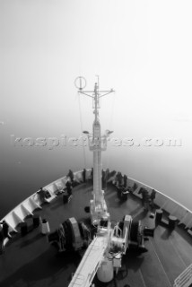 Tourists standing on the bow deck of the tourist cruise ship the Akademik Sergey Vavilov, shrouded in fog, Nordkappsundet, Spitsbergen/Svalbard, Norway, on 27 June 2007. The Akademik Sergey Vavilov is a former Russian research vessel and is now used for tourism charters in the polar regions.