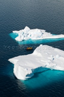 Tourists on a motorized inflatable raft known as a zodiac, cruising amongst icebergs, Paradise Harbor, Danco Coast, Graham Land, Antarctica, on the 17 November 2008. Due to its picturesque landscape, with dramatic mountains and glaciers, Paradise Harbor is visited by numerous expedition cruise ships each Antarctic summer.