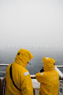 Passengers looking into thick cloud and snow while passing through the majestic Lemaire Channel, Danco Coast, Graham Land, Antarctica, on the 25 November 2008.