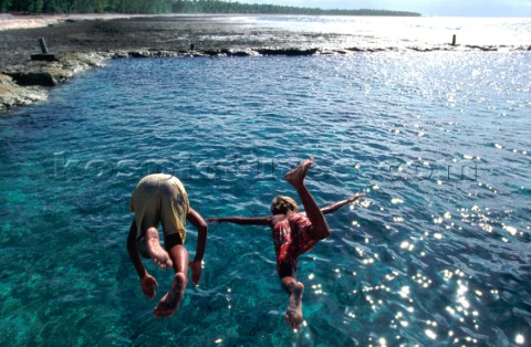 On the shores of Nukatavaki children celebrate the arrival of the cargo ship with a dive into the lo