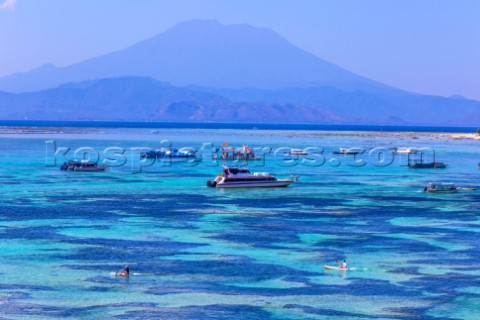 People travels by SUP surfboards at coastline of Nusa Lembongan and Nusa Ceningan islands Indonesia