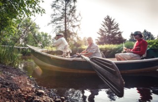 Fly fisherman heading out on the Flambeau River