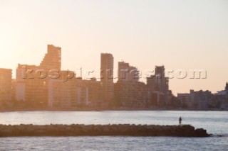 A man fishing in Calpe at sunrise.