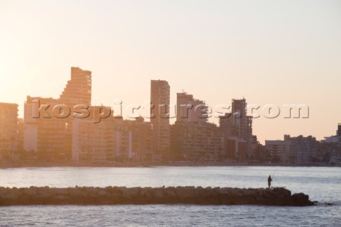 A man fishing in Calpe at sunrise