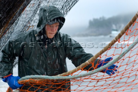 081508  Crew member Nick Demmert  hauls in the net while sein fishing on Captain Larry Demmerts boat