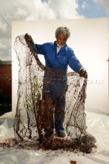 Cajun oysterman Flip Tayamen with crude oil that leaked into Barataria Bay (part of Mississippi River delta) from the explosion of the Deepwater Horizon drilling platform.