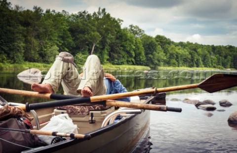 Fly Fisherman relaxing along the Flambeau River in his drift boat