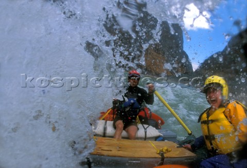 River guide and commercial client get drenched by huge wave in powerful rapids Great Bend of Yangtze