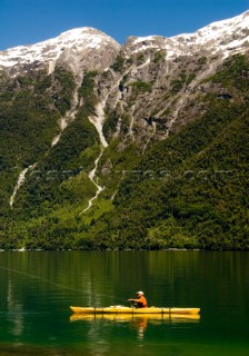 George Bahm enjoys fly fishing from his kayak during a wilderness adventure in Futaleufu, Chile.