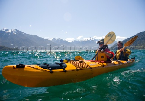 Marika Powers and Mike Powers kayak during a wilderness adventure in Lago Yelcho Chile