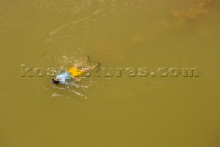 Dan Duane swimming along the shore of the Colorado River in the Grand Canyon, Arizona.