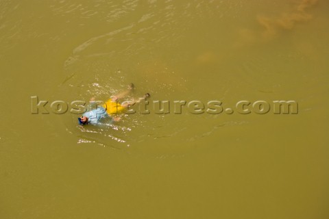 Dan Duane swimming along the shore of the Colorado River in the Grand Canyon Arizona