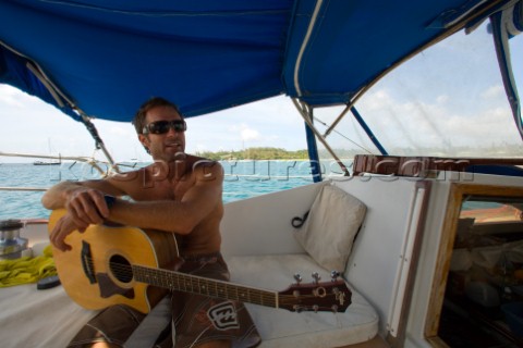 Captain Brian Carson takes a break from sailing the Nene to entertain his guests with a few songs Ha