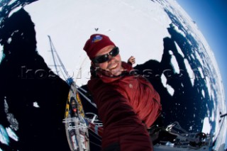 Peter McBride takes a self portrait while hanging from the mast of a sail boat which is anchored on a ice sheet. The west coast of Antarcticas peninsula known as Graham Land.