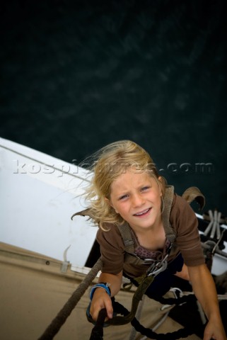 Young girl 67 years climbing the rigging of a sailboat Maine