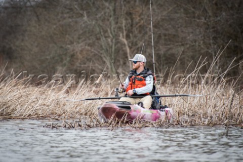 Angler in the weeds fishing the edge of the high grass in the fall