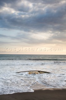 The remains of a sailboat, the  Culin, gets battered by waves on the Pacific coast of Mexico.  The sailboat washed ashore after its owner was murdered by pirates.