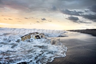 The remains of a sailboat, the  Culin, gets battered by waves on the Pacific coast of Mexico.  The sailboat washed ashore after its owner was murdered by pirates.