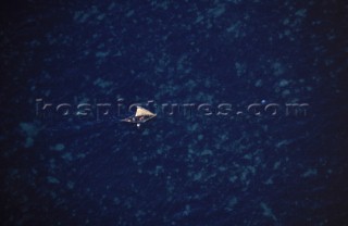 Aerial view of a fishing dhow sailing in shallow water near Kiwayu island off the northern coast of Kenya.