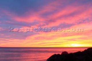 Tent on the bluffs above the central California coast during pink sunset