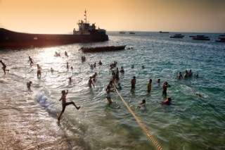 Children bathing on the beach. Stone Town. Zanzibar.