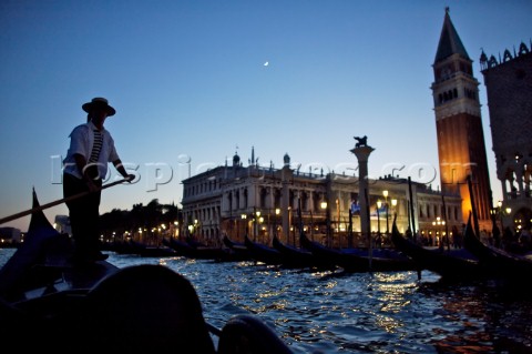 A gondolier navigates just offshore of Venice Italy at night Dave YoderAurora PhotosKos Pictures