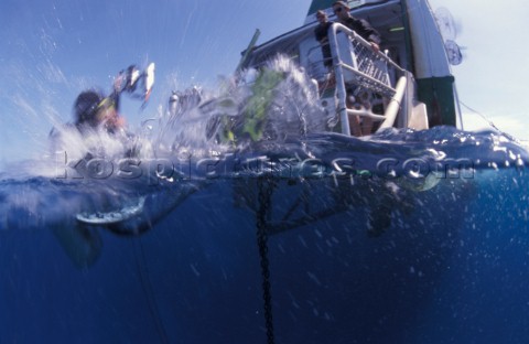 Diver jumps from the boat in the water Great Barrier Reef  Coral SeaAustralia  Juergen FreundAurora 