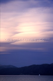 Boat sailing under thunderclouds. Lake Tahoe, CA. Justin Bailie/Aurora Photos/Kos Pictures