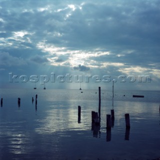 The sun sets behind sail boats as seen from the island of Caye Caulker, Belize. Karl Schatz/Aurora Photos/Kos Pictures